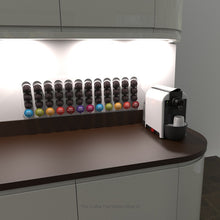 White Dolce Gusto half height coffee pod capsule holder mounted on wall under kitchen cupboard.