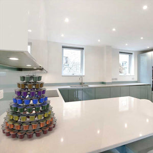 Nespresso original line coffee capsule tower stand with rotating rings, shown on kitchen worktop