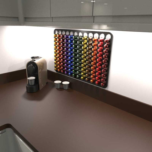 Black Nespresso original coffee pod capsule holder mounted on wall under kitchen cupboard.