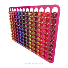 Pink, wall mounted, self adhesive Nespresso original line coffee pod capsule holder. Holds 120 pods in 12 rows.