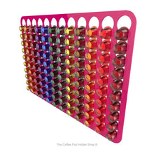 Pink, wall mounted, self adhesive Nespresso original line coffee pod capsule holder. Holds 120 pods in 12 rows.
