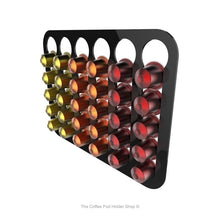 Black, wall mounted, self adhesive Nespresso original line coffee pod capsule holder. Holds 30 pods in 6 rows.