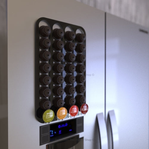 Black magnetic Dolce Gusto coffee pod capsule holder shown installed on fridge freezer.