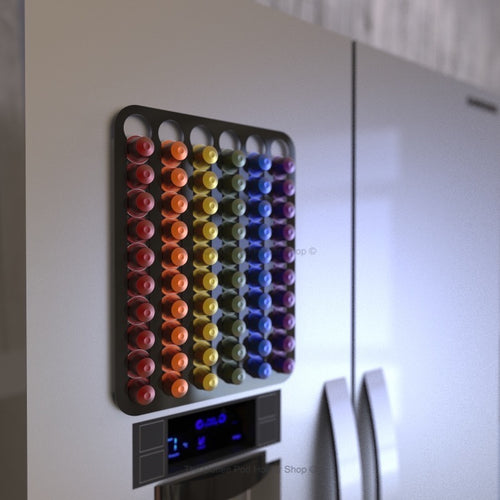 Black magnetic Nespresso original line coffee pod capsule holder shown installed on fridge freezer.