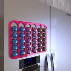 Pink magnetic Nespresso Vertuo line coffee pod capsule holder shown installed on fridge freezer.