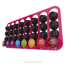 Pink, wall mounted, self adhesive Dolce Gusto coffee pod capsule holder. Holds 32 pods in 8 rows.