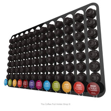 Black, wall mounted, self adhesive Dolce Gusto coffee pod capsule holder. Holds 96 pods in 12 rows.